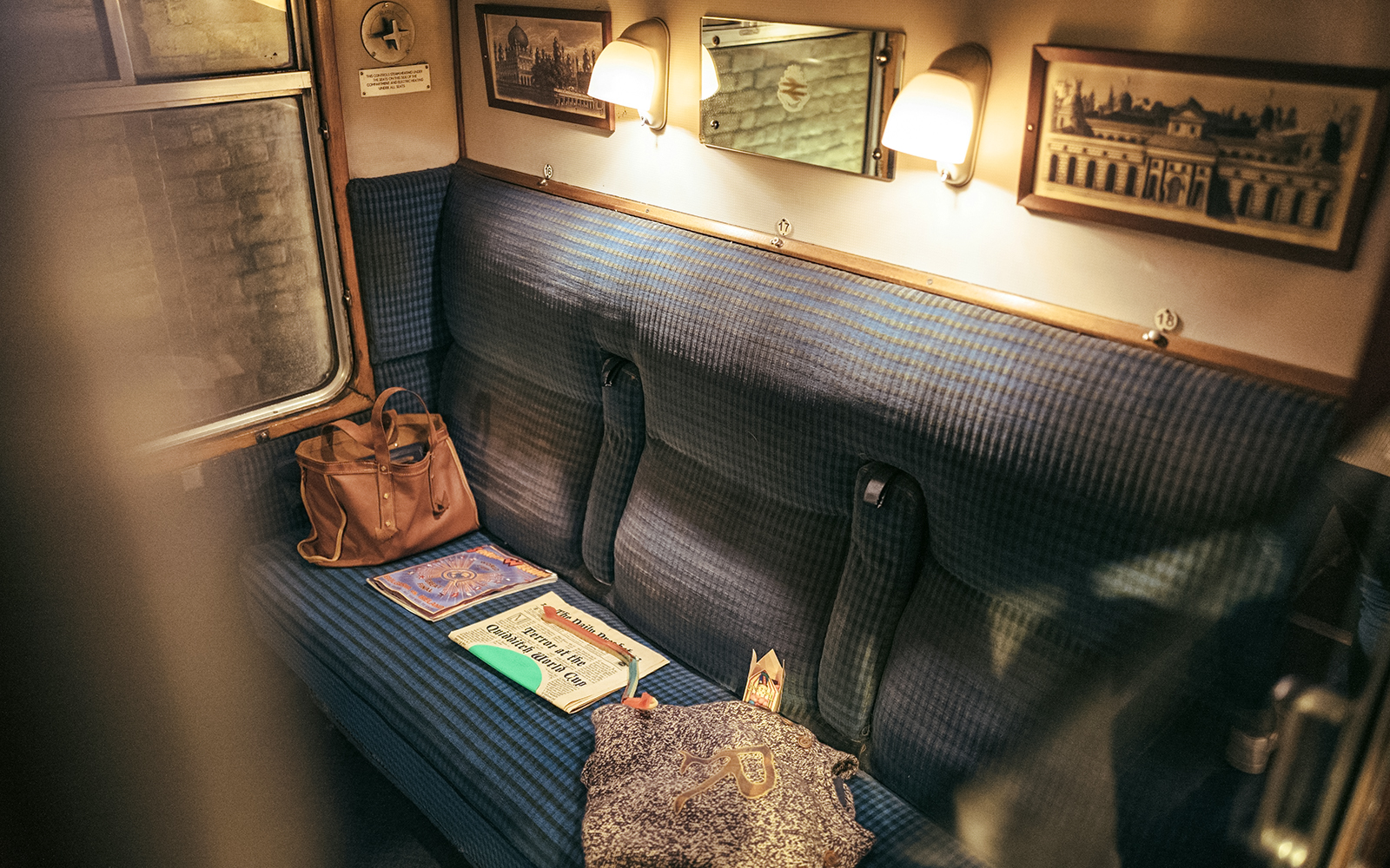 Hogwarts Express train compartment with books and a bag at Universal Orlando.