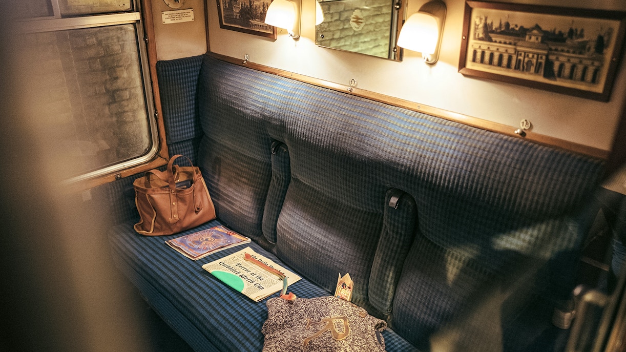 Hogwarts Express train compartment with books and a bag at Universal Orlando.