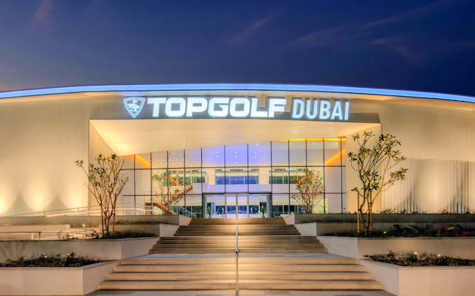 Topgolf Dubai entrance illuminated at night.
