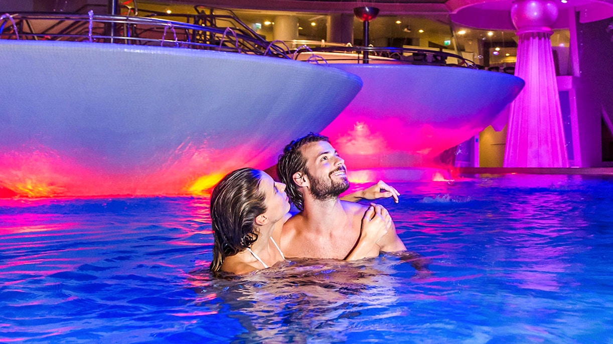 Caldea spa thermal pools with visitors relaxing in Escaldes-Engordany, Andorra.