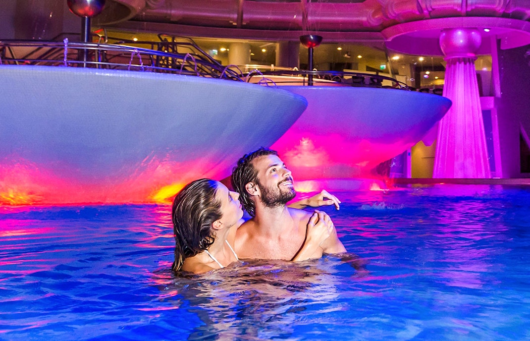 Caldea spa thermal pools with visitors relaxing in Escaldes-Engordany, Andorra.