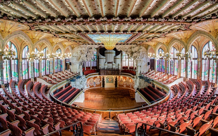Concert Hall interior at Palau de la Música Catalana, Barcelona, featuring ornate architecture and seating.