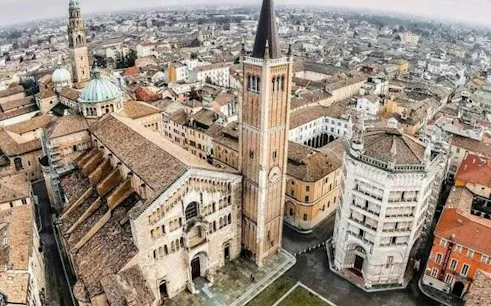 Parma cityscape with cathedral and baptistery, part of self-guided detective game tour.