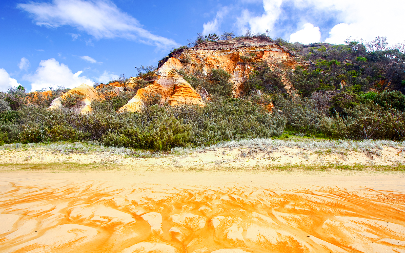 The Pinnacles' colored sands and vegetation on Fraser Island, Australia.