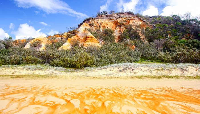 The Pinnacles' colored sands and vegetation on Fraser Island, Australia.