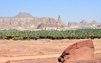 AlUla Old Town landscape with palm oasis and rocky mountains in Medina.