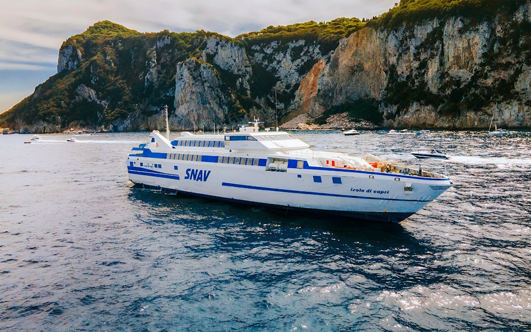 SNAV ferry sailing near Capri cliffs, route between Naples and Capri.