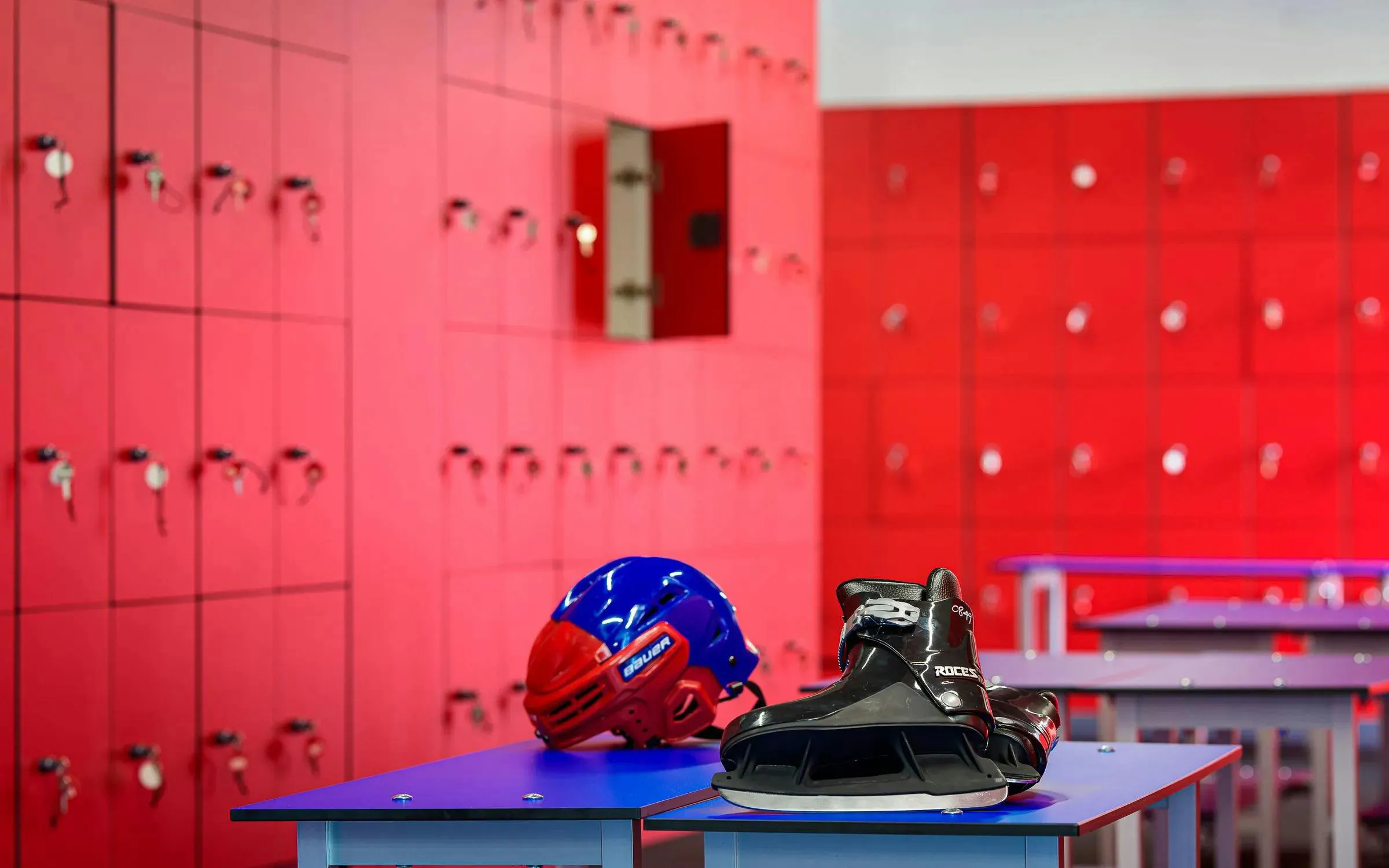 FC Barcelona Ice Rink locker room with helmet and skates on bench.