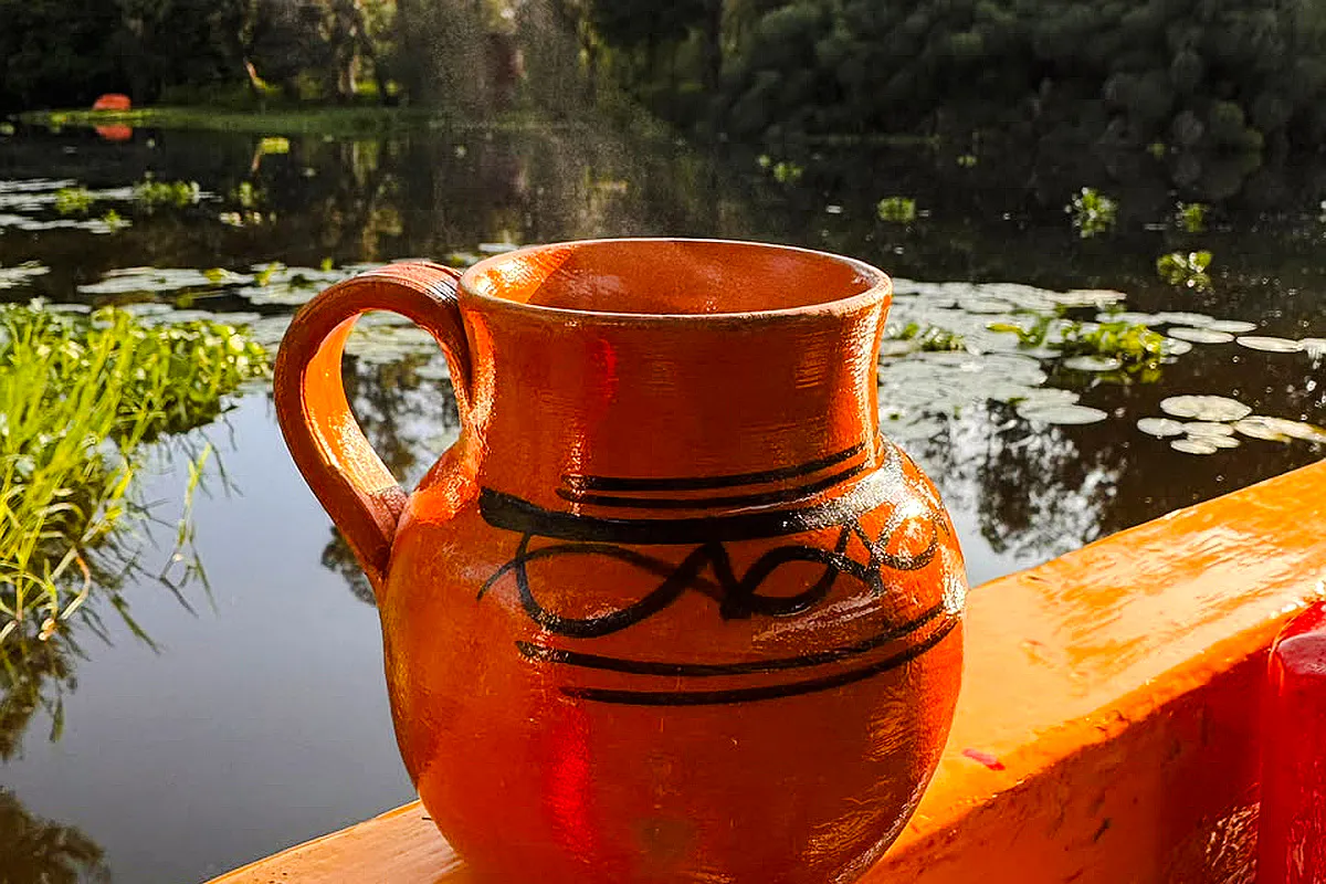Ceramic jug on a trajinera boat at sunrise in Xochimilco, Mexico City.