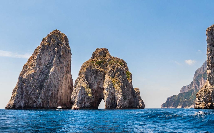 Faraglioni rock formations in Capri Island, Italy, viewed from the sea.