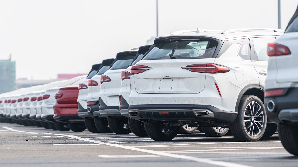 Secure car parking area with multiple parked vehicles in a city setting.
