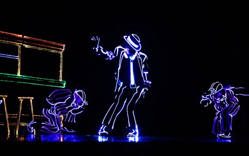 Performers in LED suits dancing in an iLuminate show.