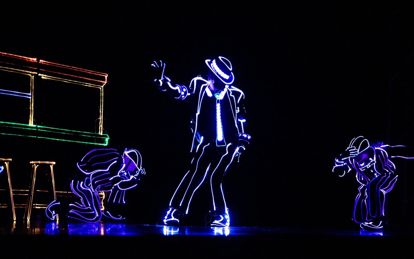 Performers in LED suits dancing in an iLuminate show.