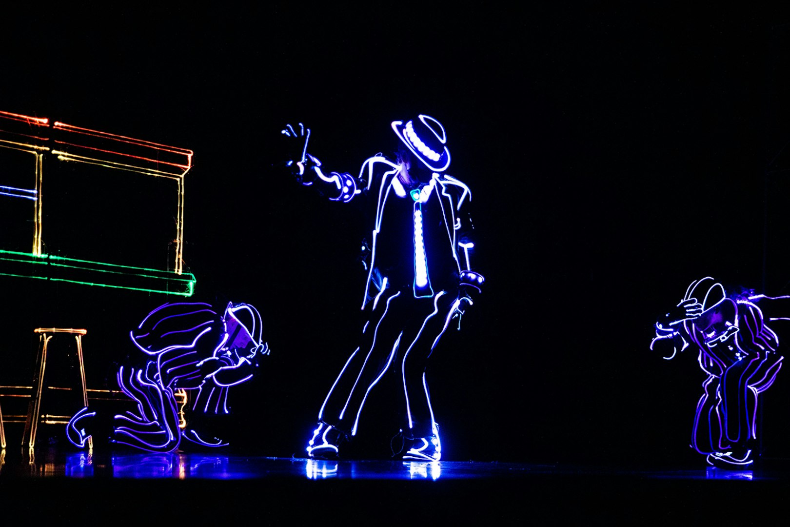 Performers in LED suits dancing in an iLuminate show.