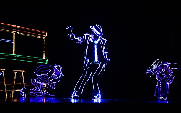 Performers in LED suits dancing in an iLuminate show.