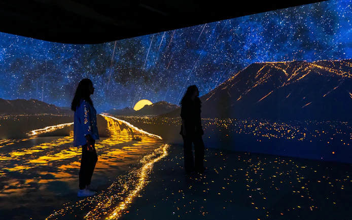Visitors exploring immersive digital landscape at London Timewalk Exhibition.