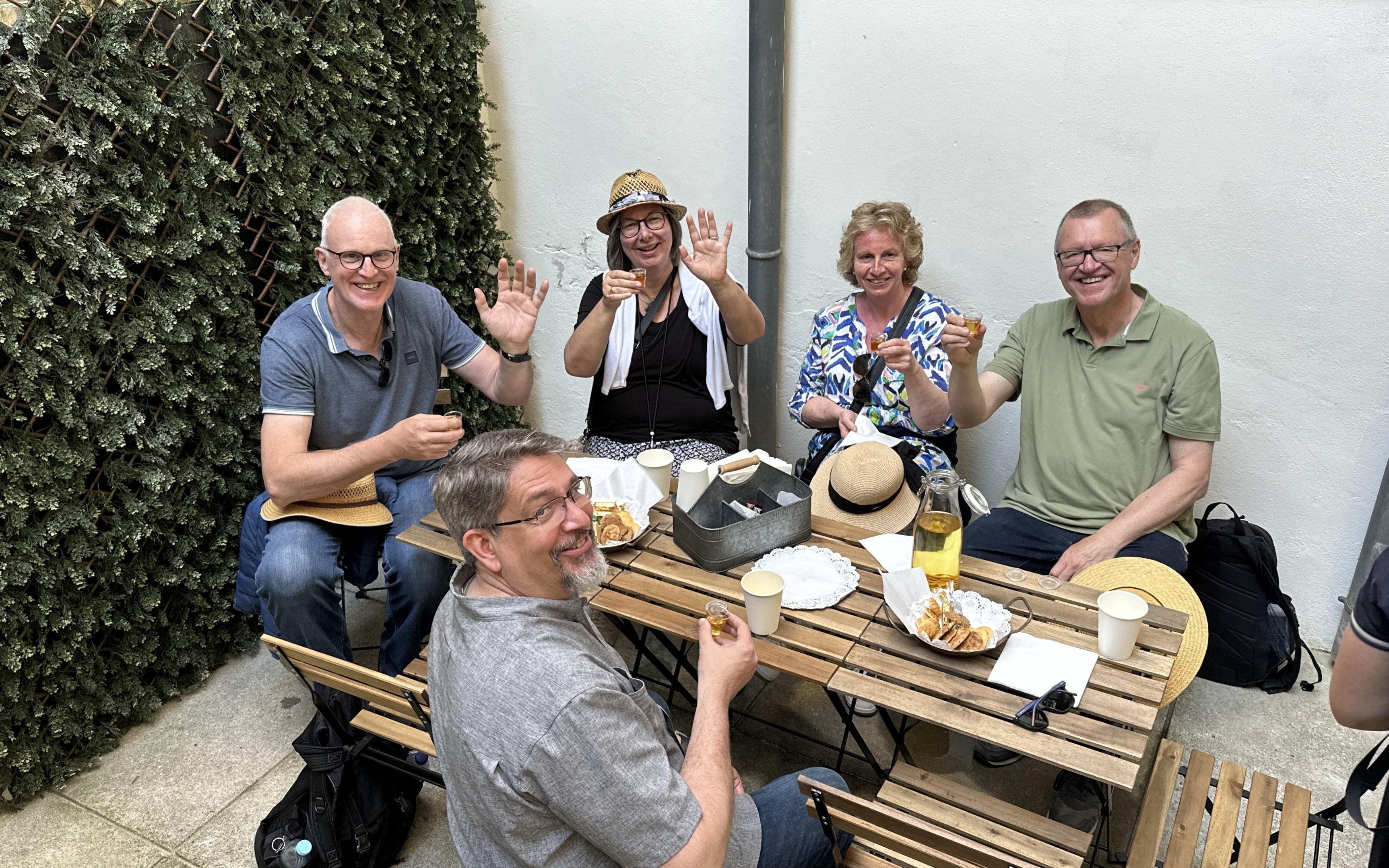 Tourists enjoying a food break with drinks and snacks at an outdoor cafe.