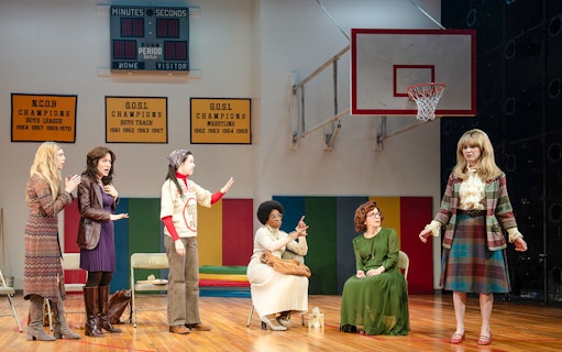 Actors performing a scene in a gymnasium setting during the Liberation Broadway show.