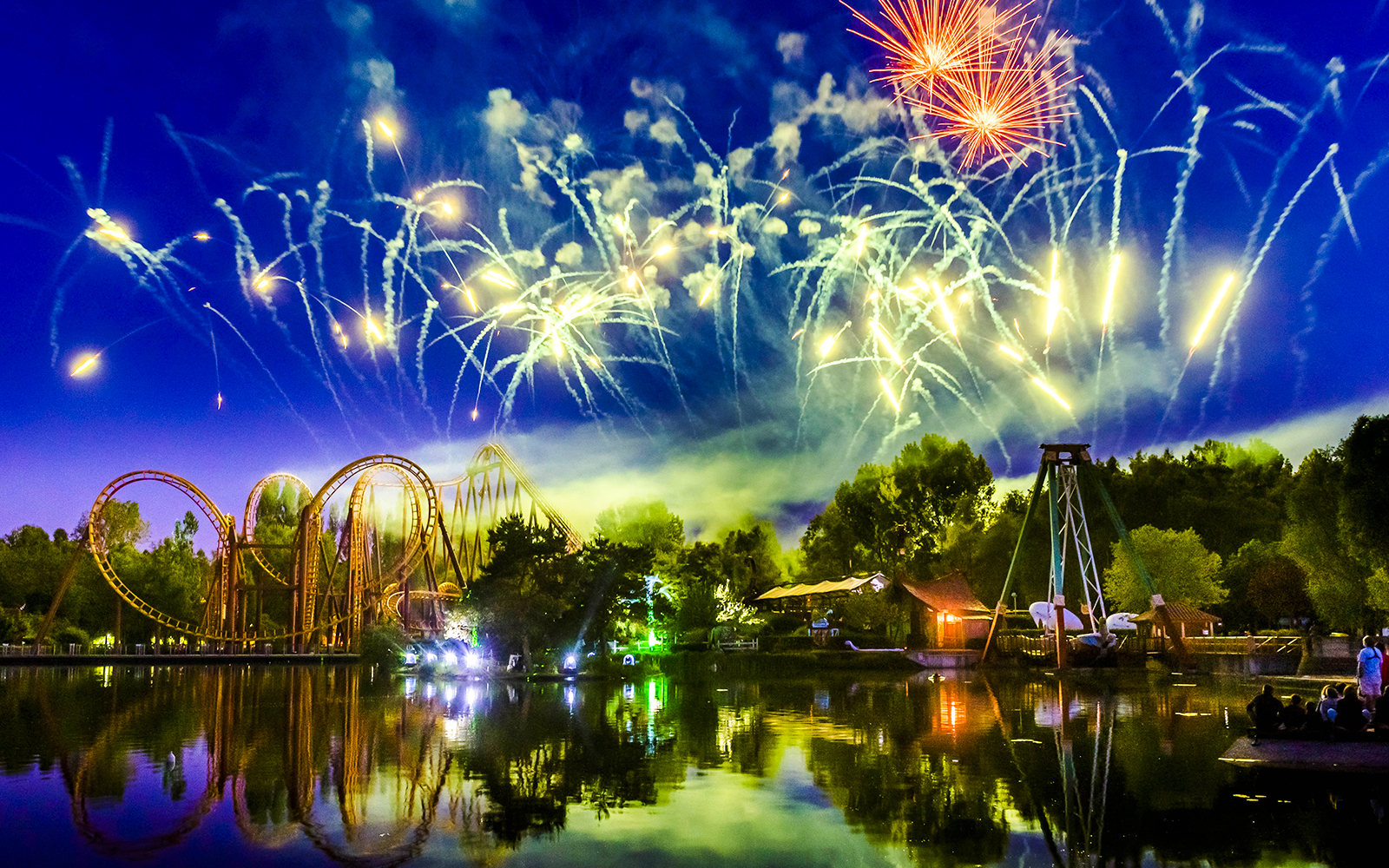 Fireworks over Parc Asterix roller coaster during Christmas celebrations.