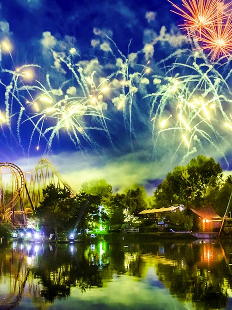 Fireworks over Parc Asterix roller coaster during Christmas celebrations.