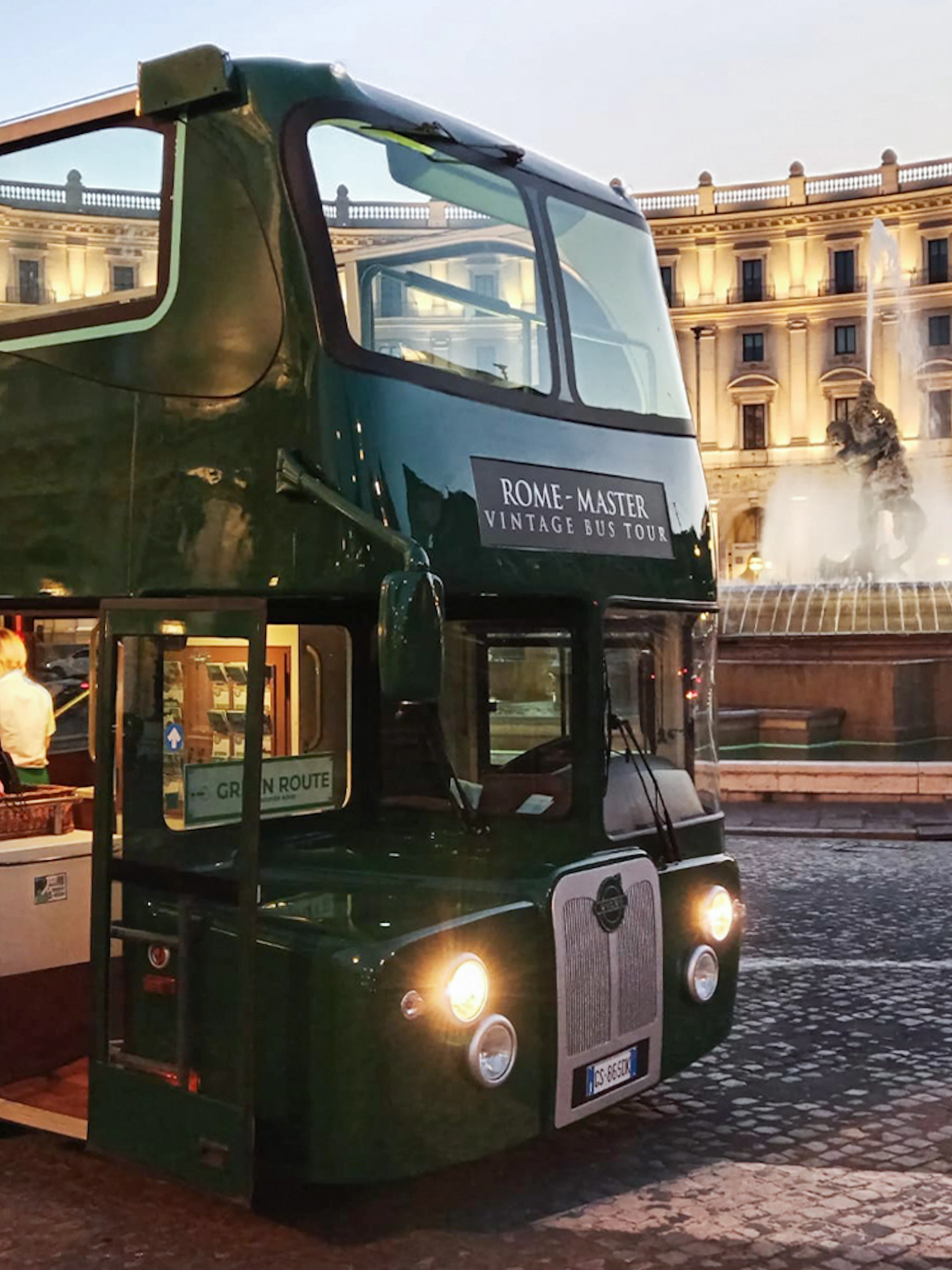 Vintage open-top double-decker bus in front of Piazza della Repubblica, Rome.