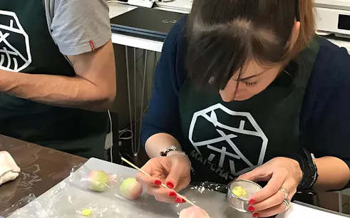 Participants crafting wagashi in a Tokyo class with tea.