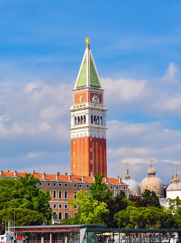 St. Mark Bell Tower in Venice with tourists admiring the view.