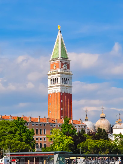 St. Mark Bell Tower in Venice with tourists admiring the view.
