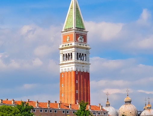 St. Mark Bell Tower in Venice with tourists admiring the view.