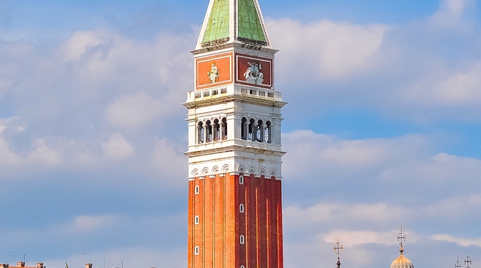 St. Mark Bell Tower in Venice with tourists admiring the view.