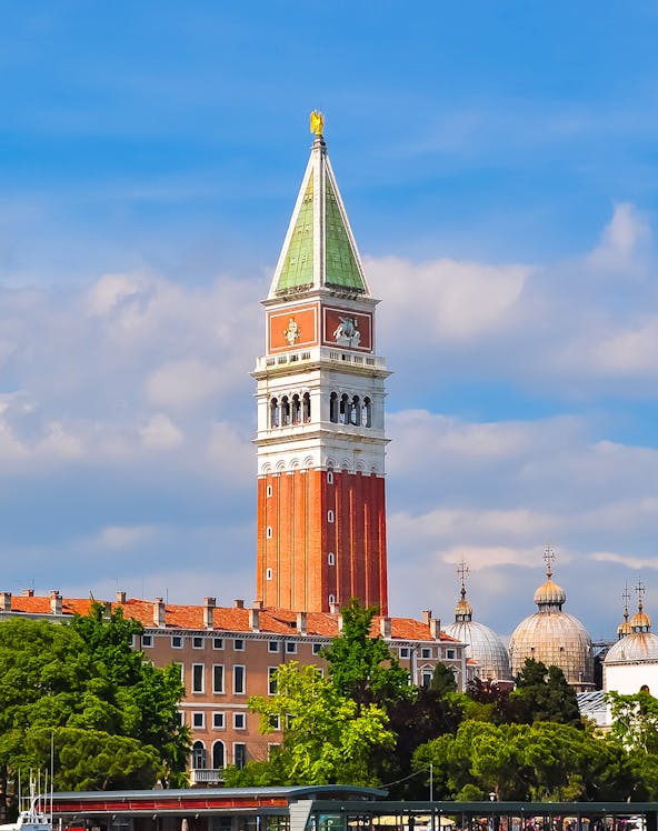 St. Mark Bell Tower in Venice with tourists admiring the view.