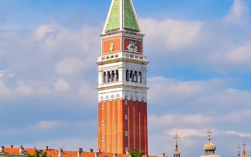 St. Mark Bell Tower in Venice with tourists admiring the view.