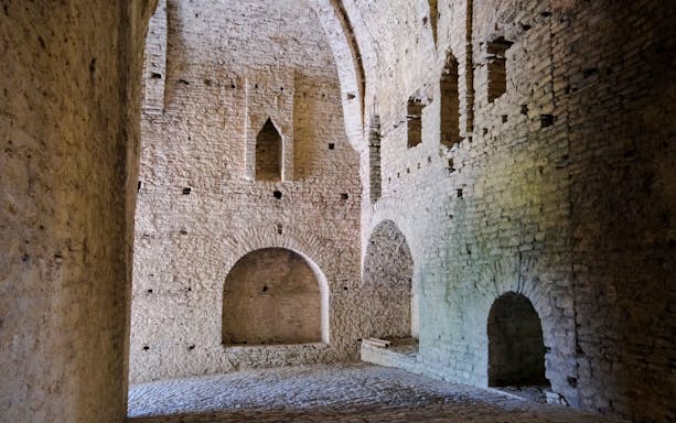 Interior stone walls and arches inside Gjirokastra Castle, Albania.