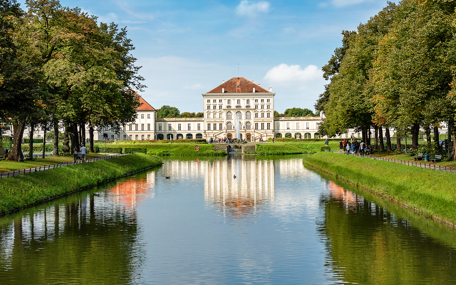 Nymphenburg Palace facade with gardens in Munich, showcasing baroque architecture.