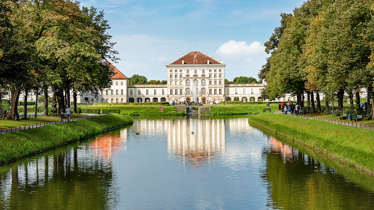 Nymphenburg Palace facade with gardens in Munich, showcasing baroque architecture.