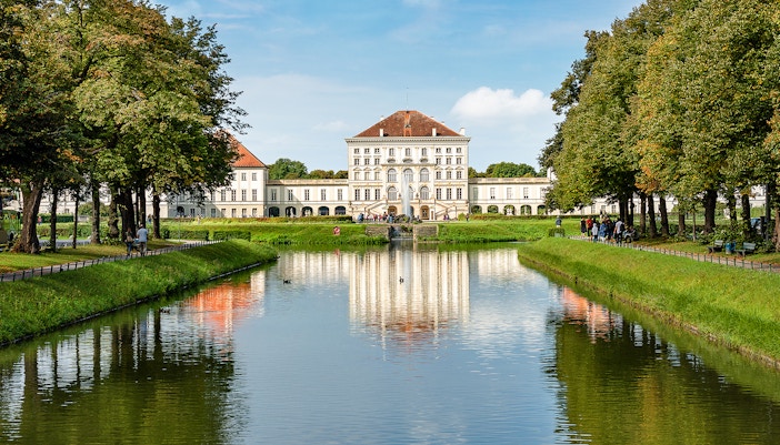 Nymphenburg Palace facade with gardens in Munich, showcasing baroque architecture.