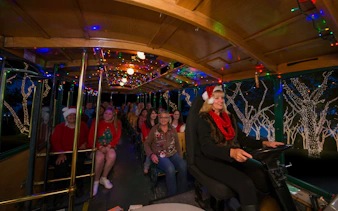 Passengers enjoying Old Town Trolley's Holiday Sights and Festive Nights Tour in San Diego.