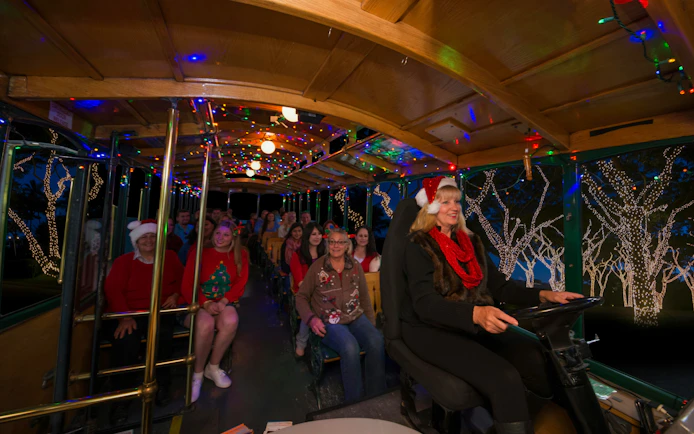 Passengers enjoying Old Town Trolley's Holiday Sights and Festive Nights Tour in San Diego.