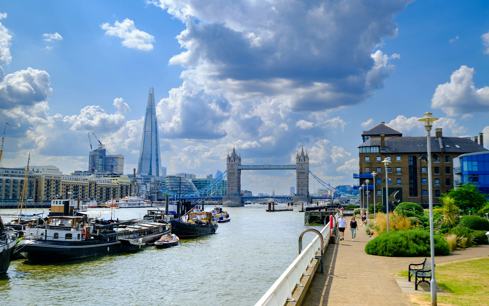 River Thames view from Waterside Gardens, London, featuring Tower Bridge and the Shard in the distance.