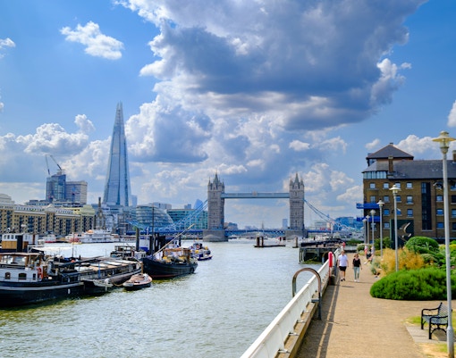 River Thames view from Waterside Gardens, London, featuring Tower Bridge and the Shard in the distance.