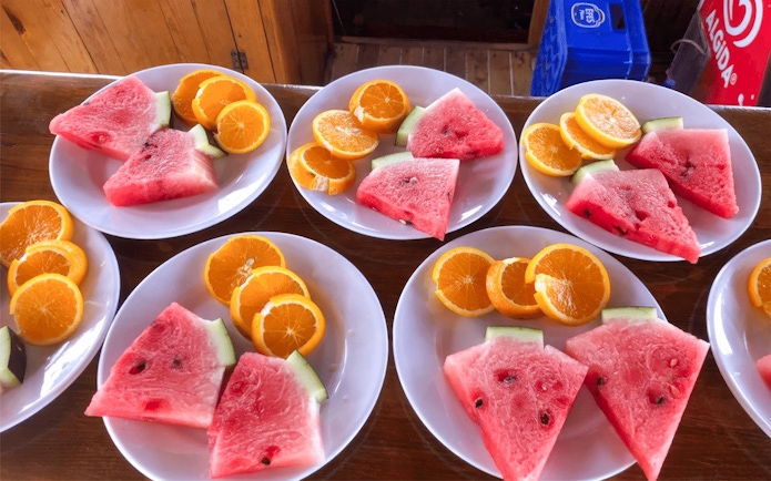 Plates of watermelon and orange slices on Alanya Relaxing Boat Tour.
