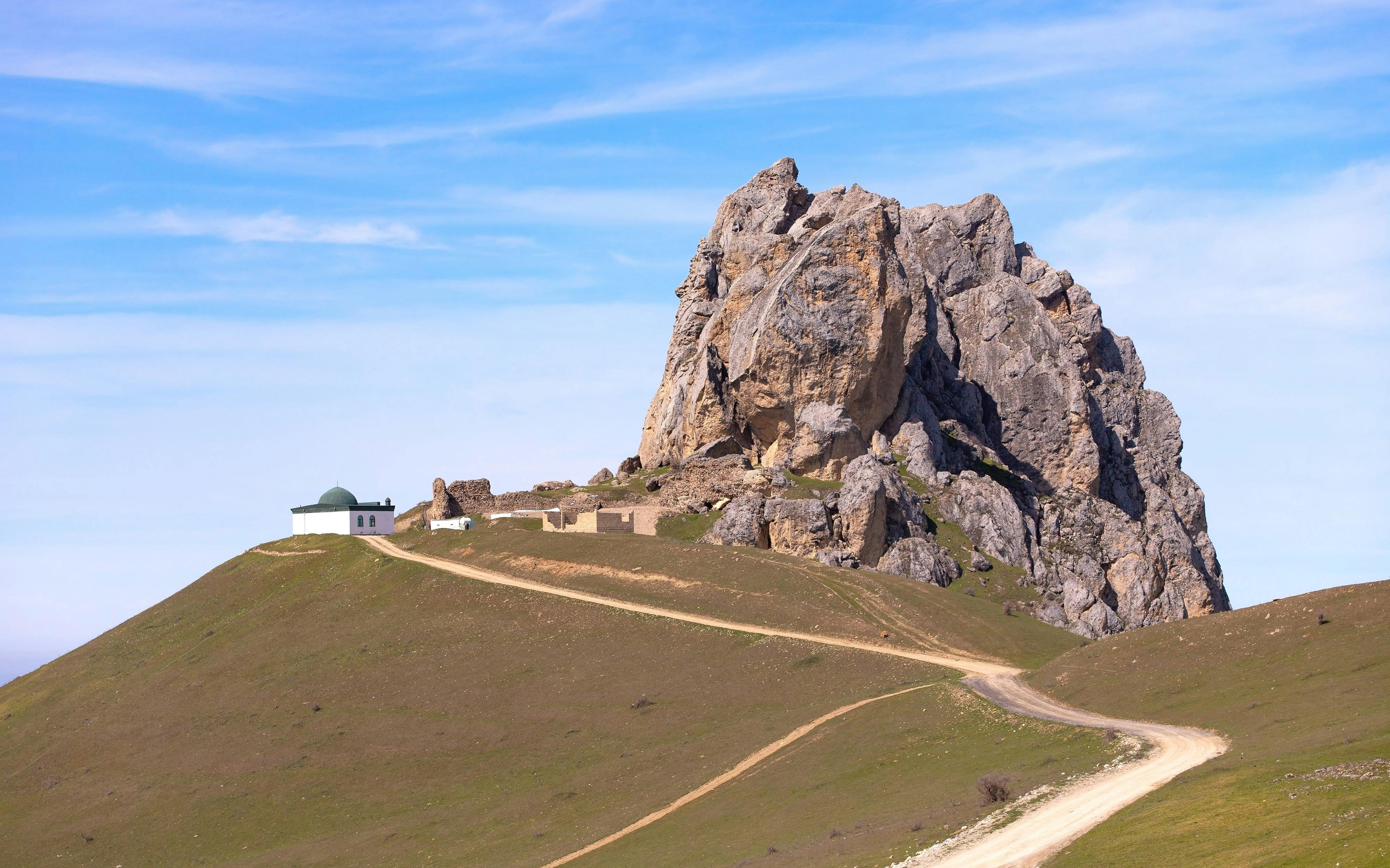 Five Fingers Mountain with a small building on a hill, Baku, Azerbaijan.