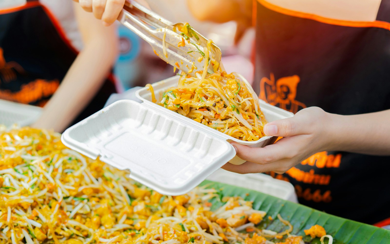Serving Pad Thai at a street food stall in Thailand.