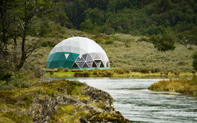 Geodesic dome near river in Tierra del Fuego National Park.