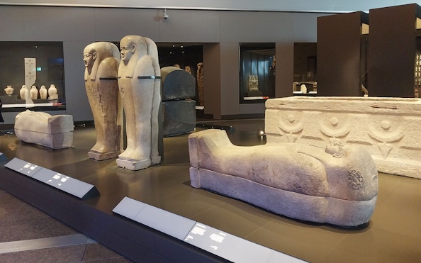 Ancient Egyptian sarcophagi displayed at the Grand Egyptian Museum.
