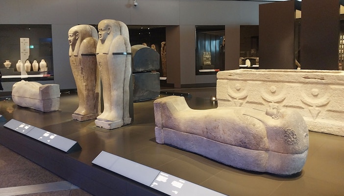Ancient Egyptian sarcophagi displayed at the Grand Egyptian Museum.