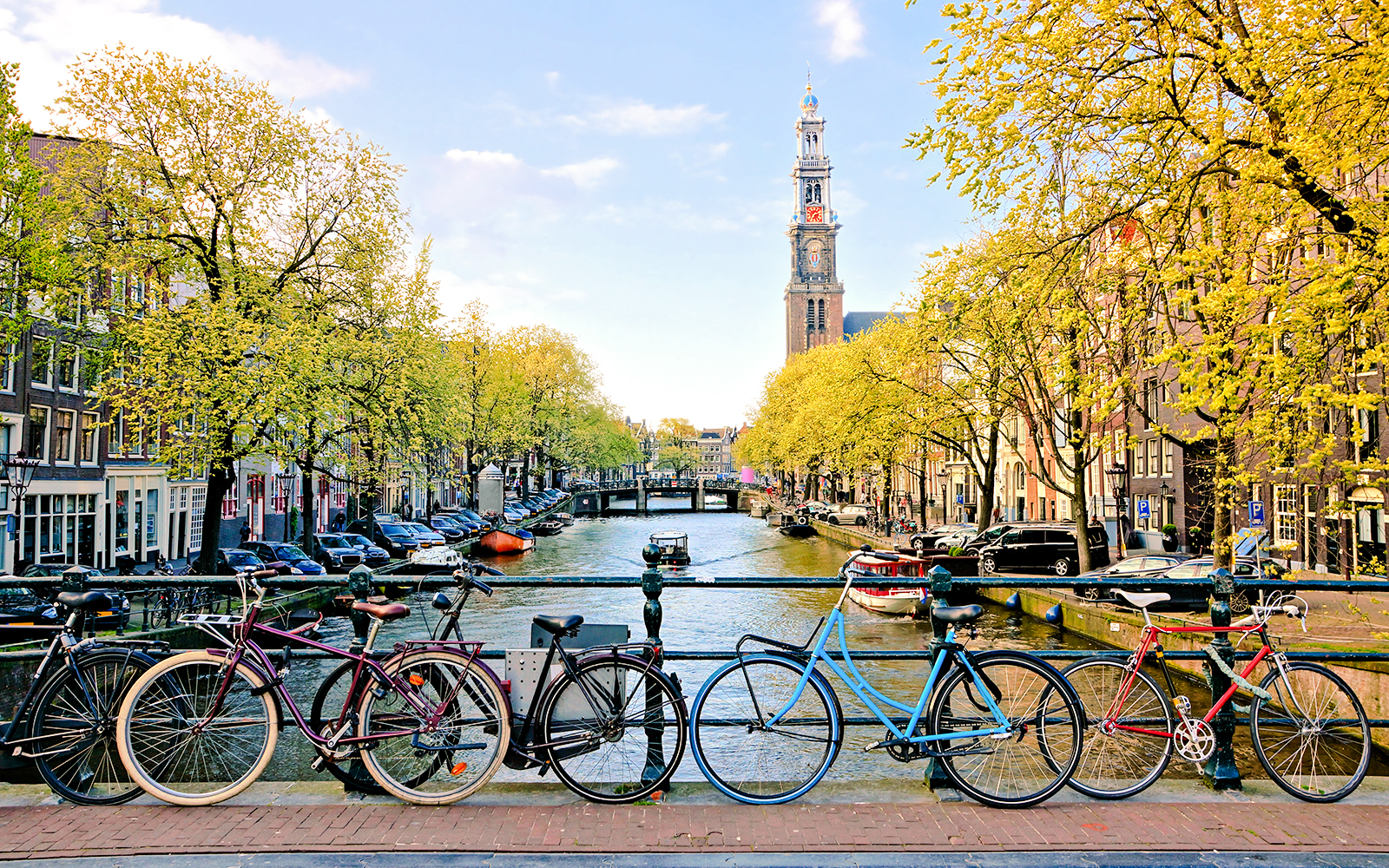 Bicycles parked on a bridge over a canal near Amsterdam Centraal Station.