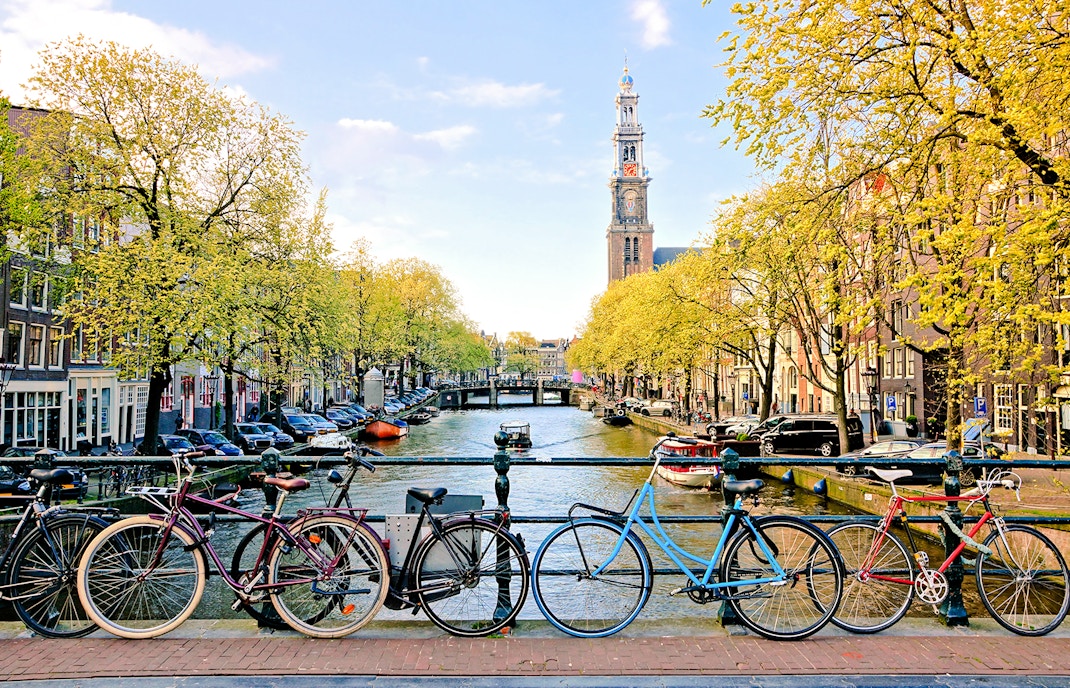 Bicycles parked on a bridge over a canal near Amsterdam Centraal Station.