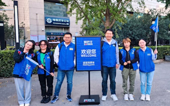 Tour guides at Mutianyu Great Wall bus tour meeting point near Dengshikou Station.