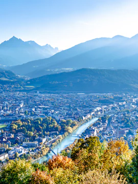 Hungerburg view of Innsbruck cityscape with mountains and river.